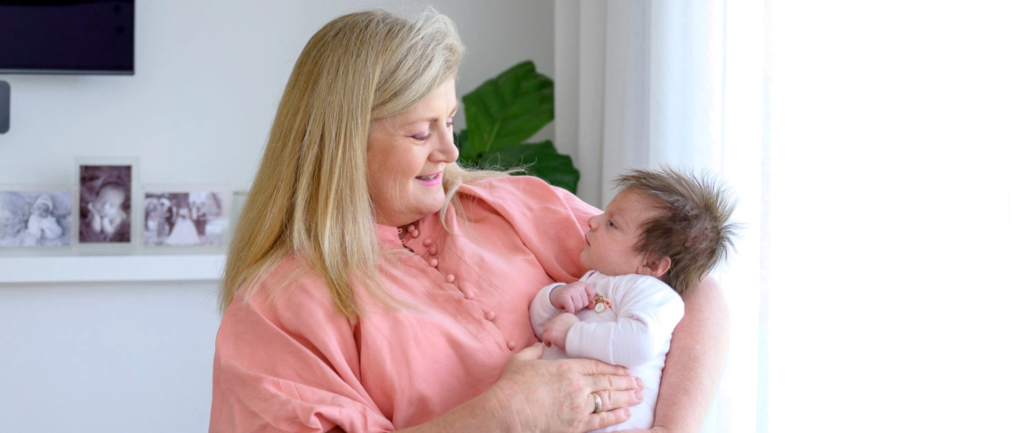 Kate Bergamasco holding a newborn baby